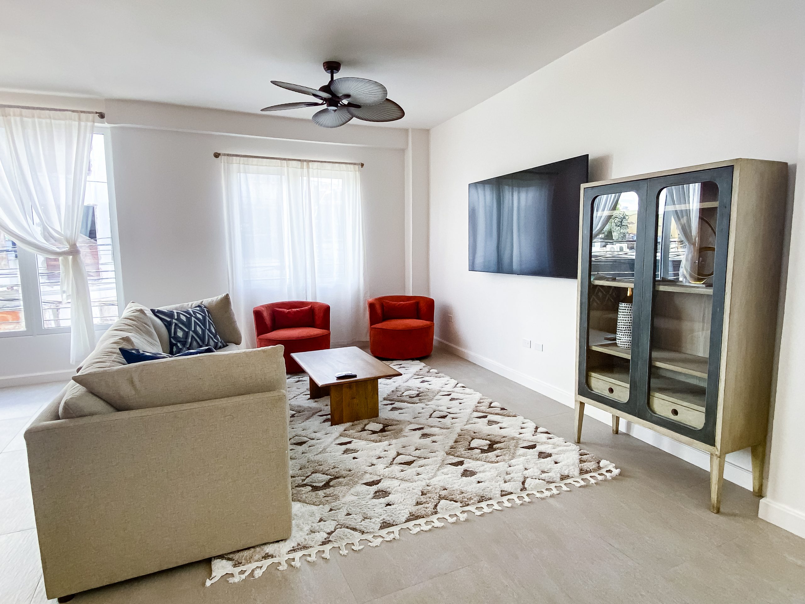 two patrons enjoy a cocktail in a cabana